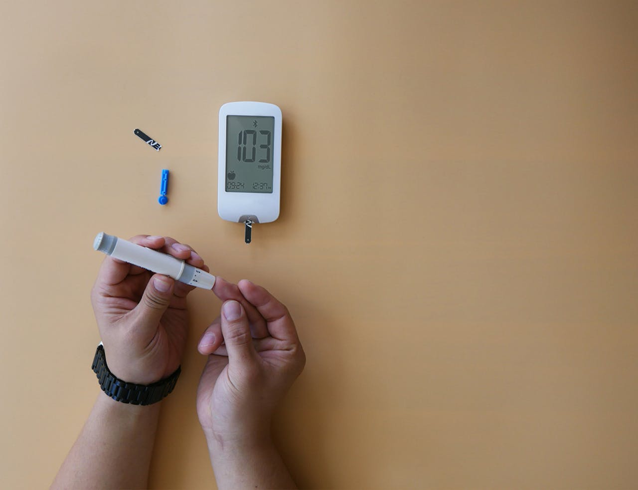 Close-up of a person using a glucose meter for blood sugar testing.