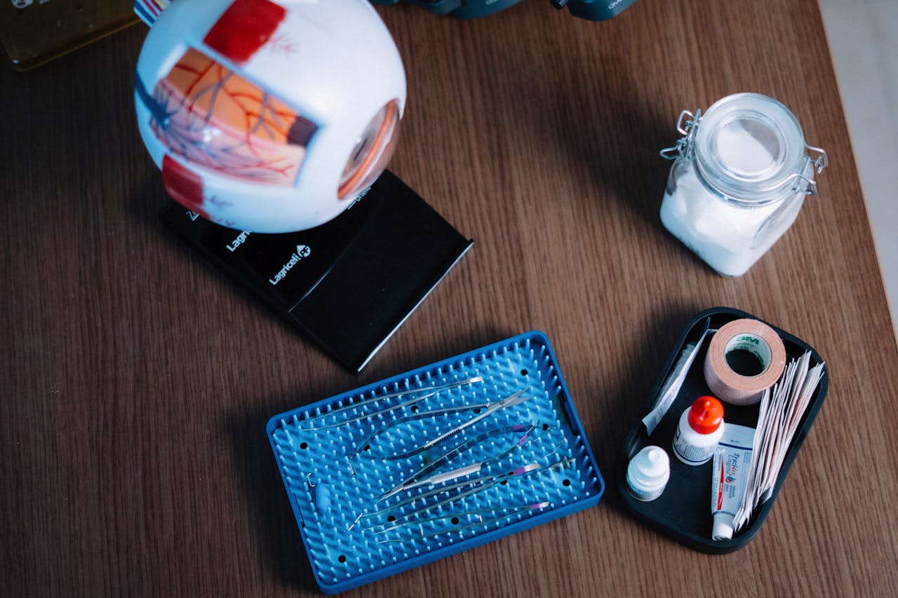 Medical supplies and anatomy model on a wooden desk, ideal for educational purposes.