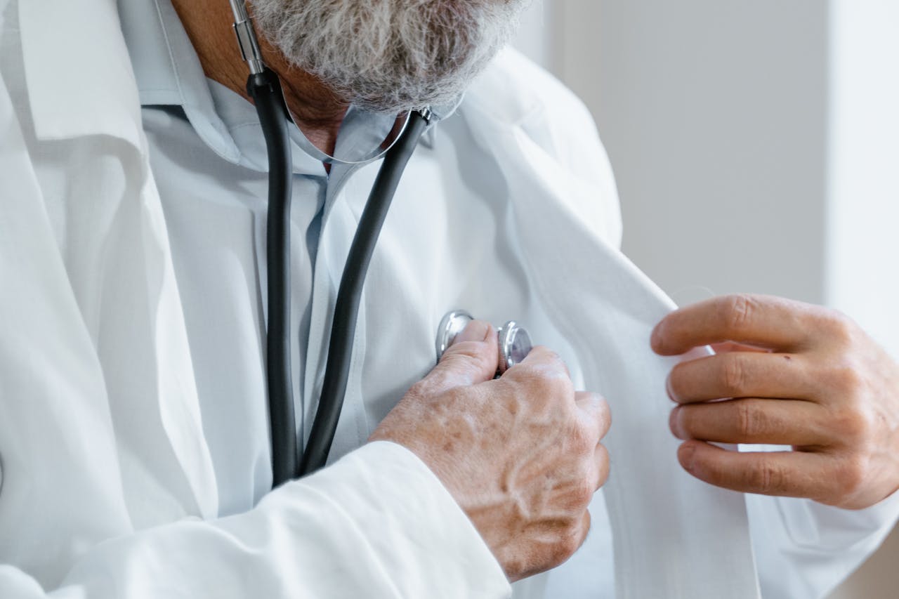 Close-up of a doctor adjusting a stethoscope while in a medical consultation.